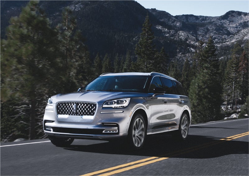 A 2023 Lincoln Aviator® Grand Touring SUV being driven on a winding road to demonstrate the capabilities of all-wheel drive | West Point Lincoln in Houston TX