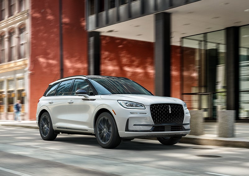 The 2024 Lincoln Corsair® SUV with the Jet Appearance Package and a Pristine White exterior is parked on a city street. | West Point Lincoln in Houston TX