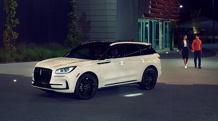 Two people approach a 2024 Lincoln Corsair® SUV featuring the available Jet Appearance Package. | West Point Lincoln in Houston TX