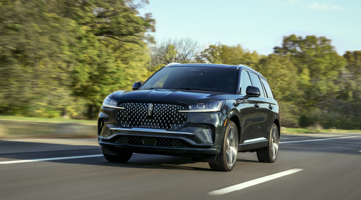 A 2025 Lincoln Black Label Aviator® SUV is being driven down a road lined with trees. | West Point Lincoln in Houston TX