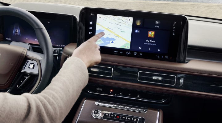 A person is tapping the center display touchscreen of a 2026 Lincoln Aviator® SUV. | West Point Lincoln in Houston TX