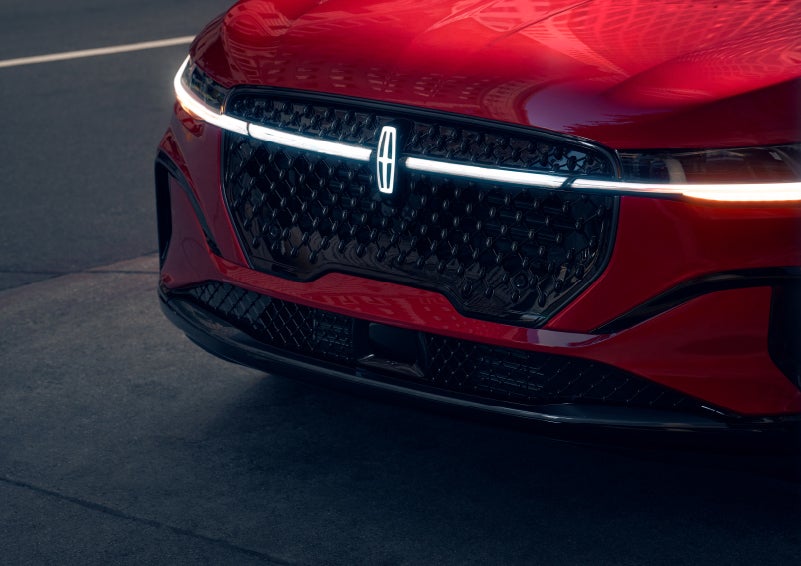 The available front LED light bar and center Lincoln Star logo glow at dusk. | West Point Lincoln in Houston TX