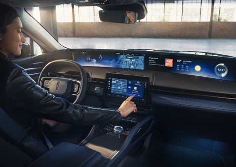 The driver of a 2026 Lincoln Nautilus® SUV interacts with the center touchscreen. | West Point Lincoln in Houston TX