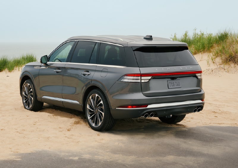 A 2027 Lincoln Aviator® SUV is parked next to sand dunes. | West Point Lincoln in Houston TX