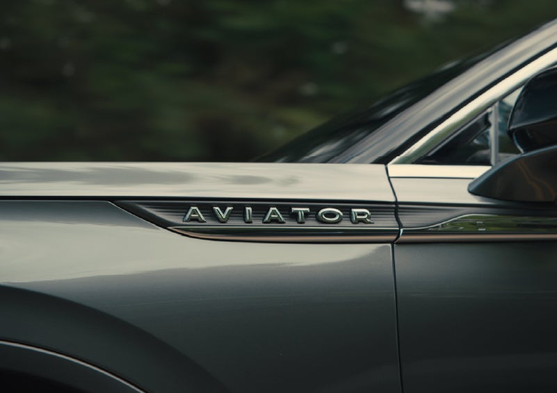 The driver’s side door and fender badging of a gray 2027 Lincoln Aviator® SUV are showcased. | West Point Lincoln in Houston TX