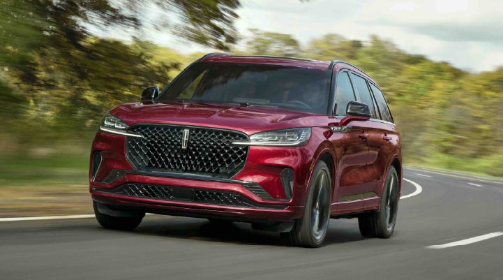 A 2027 Lincoln Aviator® SUV is being driven on a country road | West Point Lincoln in Houston TX