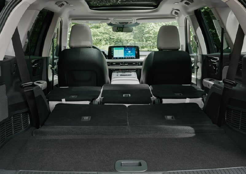 A rear to front view of the interior of a 2027 Lincoln Aviator® Black Label™ SUV shows the third and second rows folded flat | West Point Lincoln in Houston TX