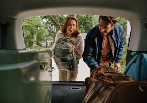 A couple loads luggage into the rear of a 2027 Lincoln Aviator® Black Label™ SUV..e 202 | West Point Lincoln in Houston TX