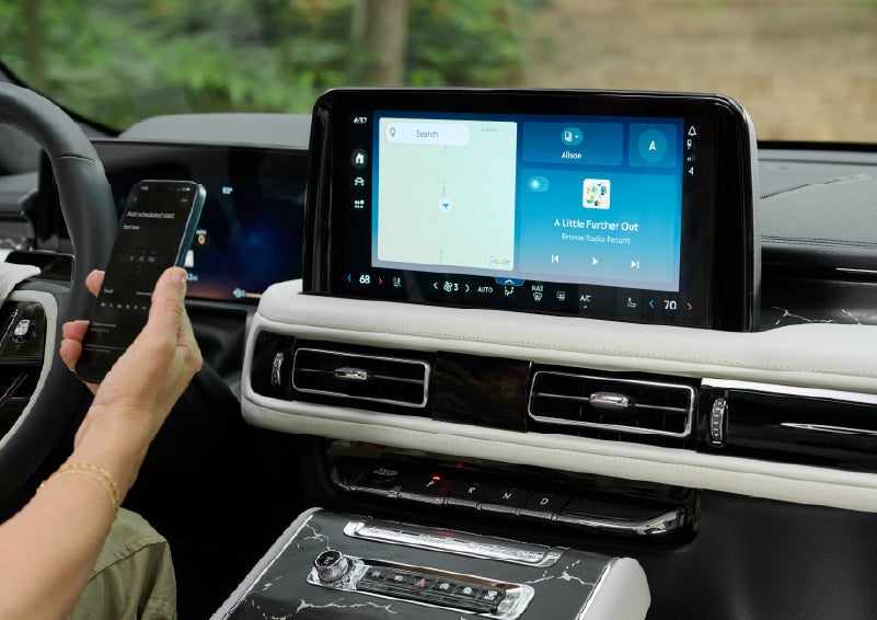 A person pairs thier phone with the center touchscreen of a 2027 Lincoln Aviator® Black Label™ SUV | West Point Lincoln in Houston TX